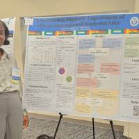 Ophelia Zornu in front of her poster presentation.